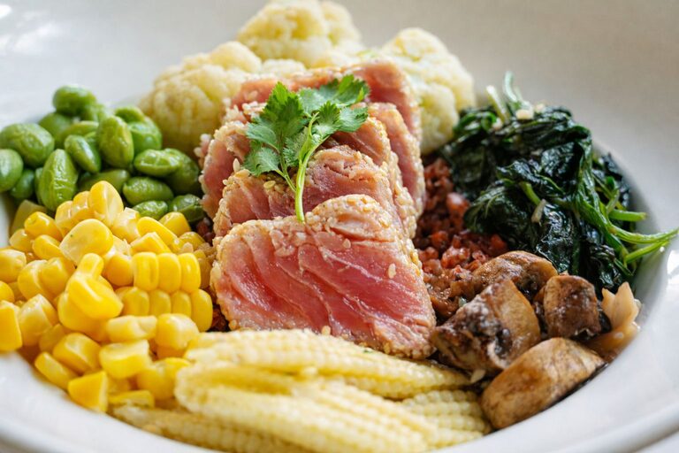 Sesame crusted tuna over brown rice with edamame, sweetcorn, baby corn, cauliflower, spinach and mushrooms.